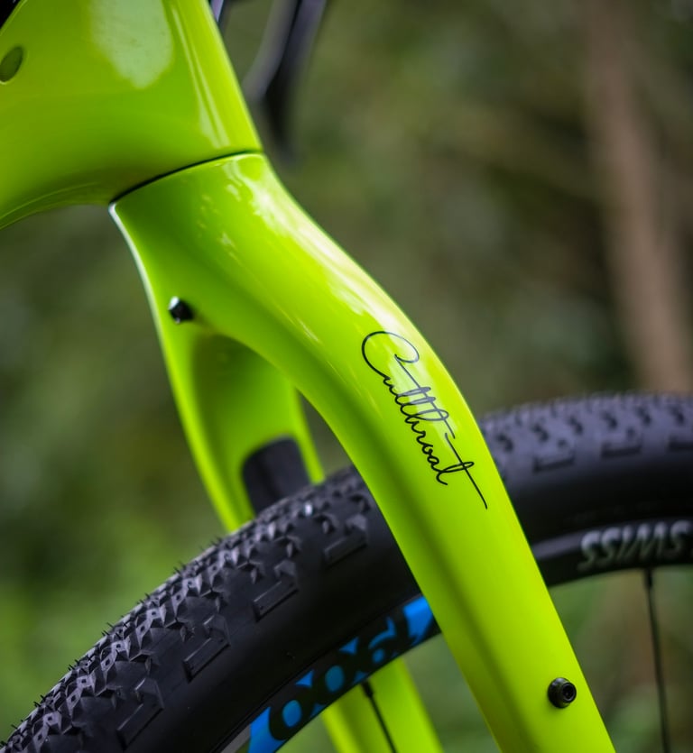 Close-up of the Cutthroat script logo on the lime green fork of the 2020 Salsa Cutthroat.