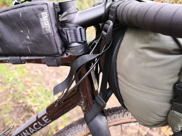 Straight Cut Design handlebar harness straps looped through the fork crown and held by a tri-glide buckle.