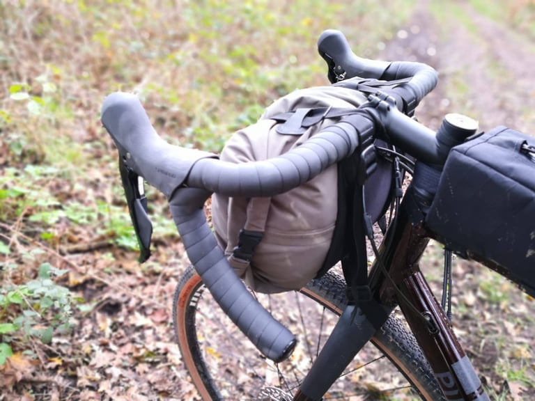 13L dry bag in the Straight Cut Design handlebar harness, sitting clear of the brake levers on a drop-bar bike.