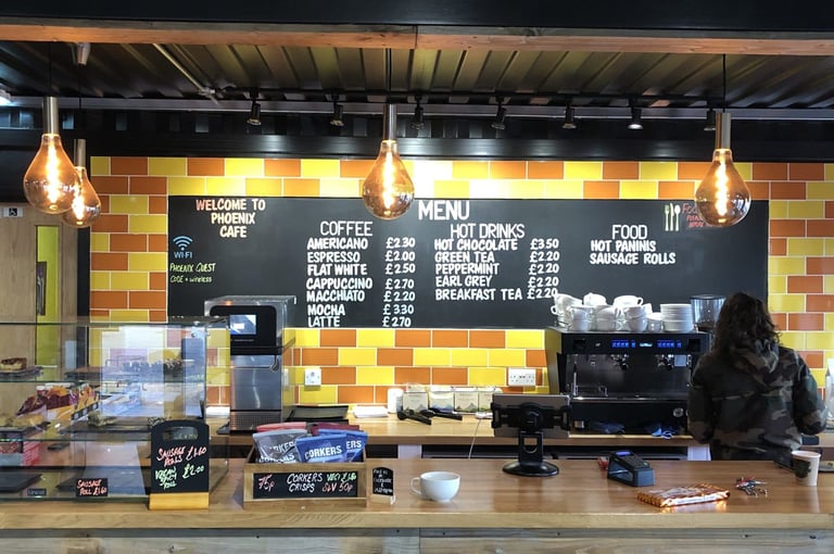 Phoenix Cycleworks cafe counter with coffee machine and chalkboard menu, the start of the Suffolk Gravel social ride.