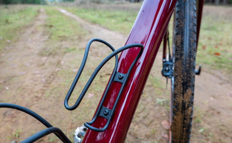 Black Cerakote King Cage Iris bottle cage, Keep Pedalling edition, bolted to the Cervelo Aspero frame.