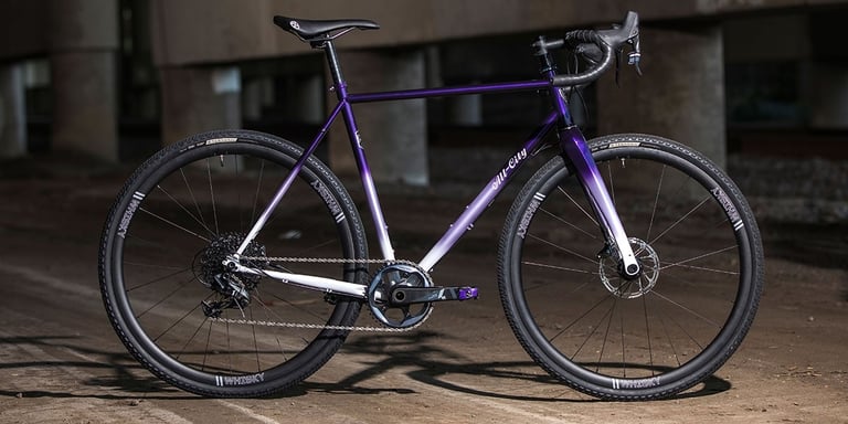 2020 All-City Cosmic Stallion Force 1 in purple fade with SRAM 1x drivetrain and Whisky carbon wheels, side view.