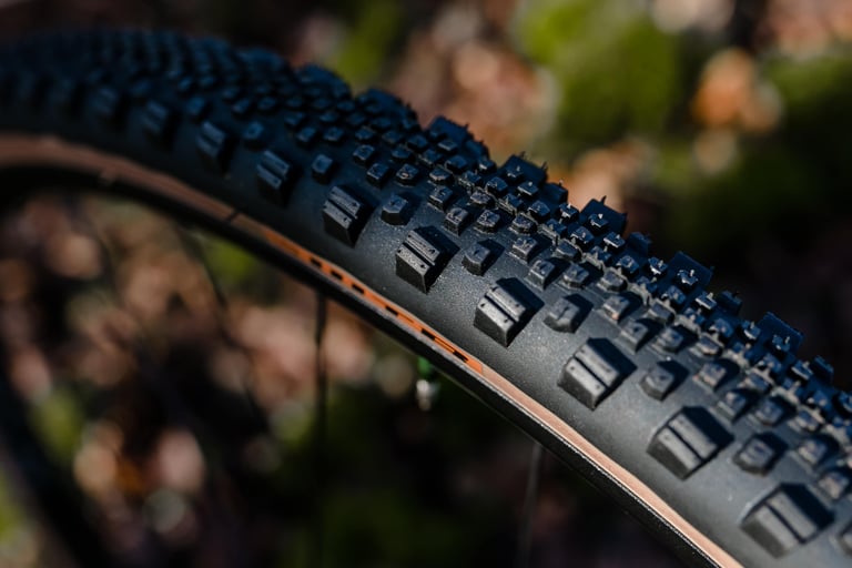 Close-up of the WTB Raddler tread, with tall centre and outer knobs and a tan sidewall.
