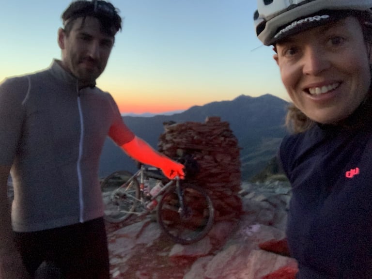 Emma Osenton and frame builder Rob Quirk in a dawn selfie by the summit cairn on Mont Fourcat during Further.