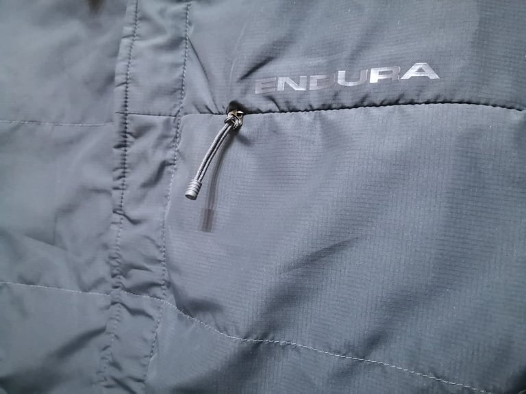 Windproof side of the Endura Hummvee Shacket with grey-on-grey branding and a cord-pull zip pocket.