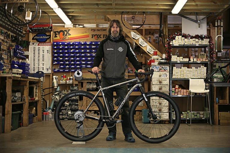 Graham Foot of Smokestone and Slam 69 stands behind the Mr Harry titanium bike in his Gloucester workshop.