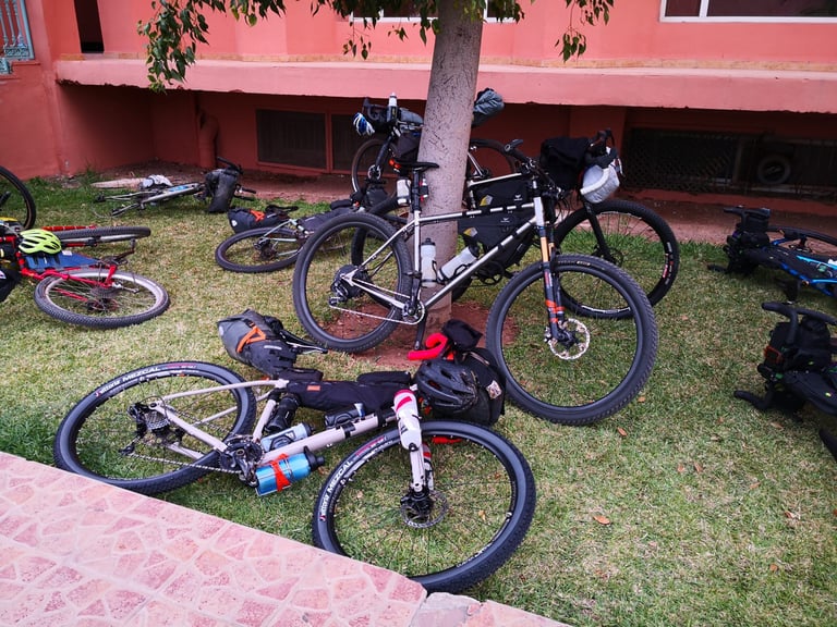 Bikepacking bikes laid on the lawn at the Mogador Kasbah hotel, race HQ for the Atlas Mountain Race.