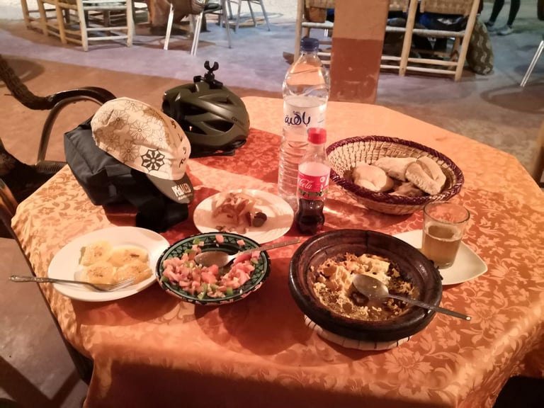 Tagine, salad, bread and Coca-Cola on a table at Checkpoint 1 of the Atlas Mountain Race in Morocco.