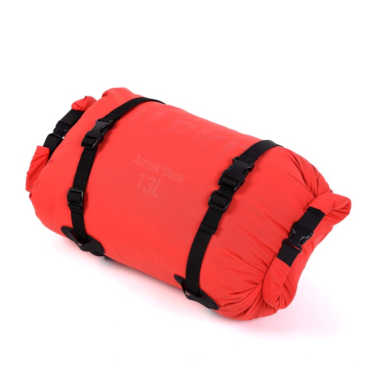 Red ALPKIT Airlok Dual 13 litre drybag with black webbing straps, rolled closed at both ends, on a white background.