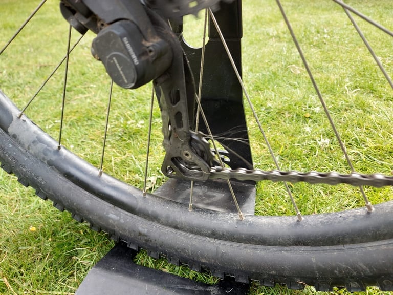 Tru-Tension BananaSlip wet lube on the chain and jockey wheel of a rear derailleur, bike in a workstand.