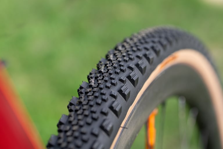 Angled view of the tread on a tanwall WTB Raddler 700x40, showing dense centre knobs and side lugs.
