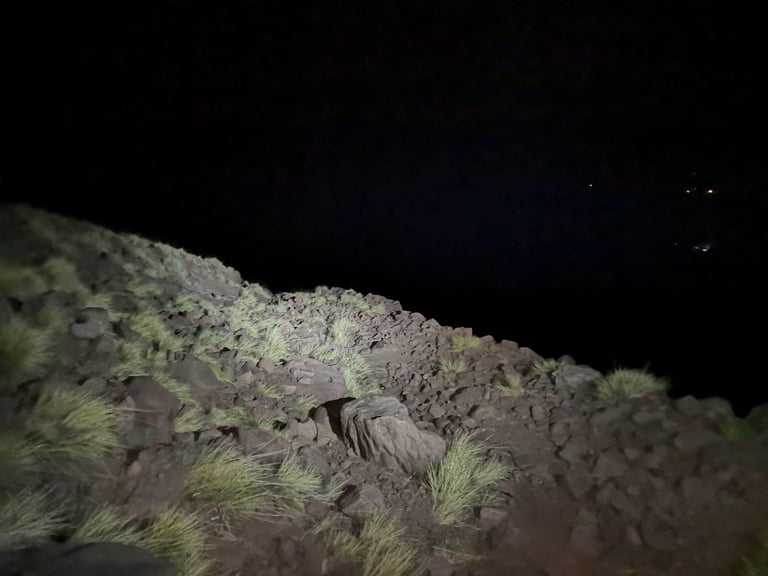 Headlight-lit rocky ground on the Telouet Pass hike-a-bike at night during the Atlas Mountain Race.