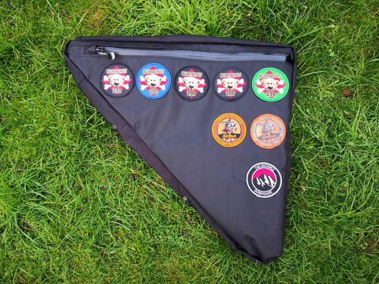 Non-drive side of the Straight Cut Design frame bag, with Bear Bones 200 and Dirty Reiver event patches sewn on.
