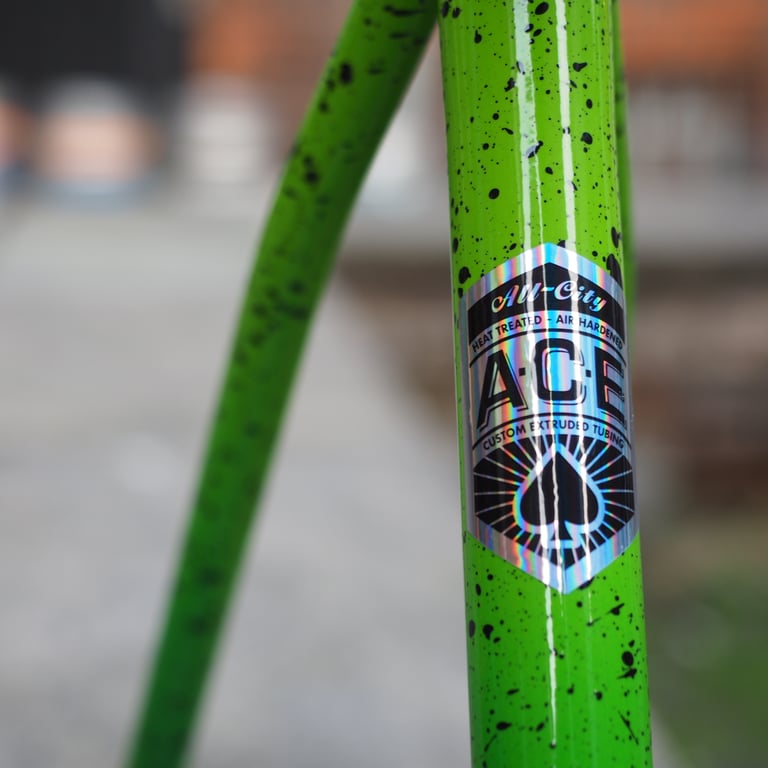 All City A.C.E. custom extruded tubing sticker on the green Nature Boy frame.