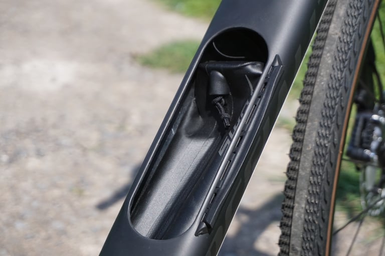 Open SWAT door on the Diverge downtube showing the in-frame storage pouch for tools and spares.
