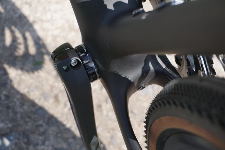 Close-up of the Specialized Diverge chainstay and front derailleur showing the tyre clearance behind the bottom bracket.