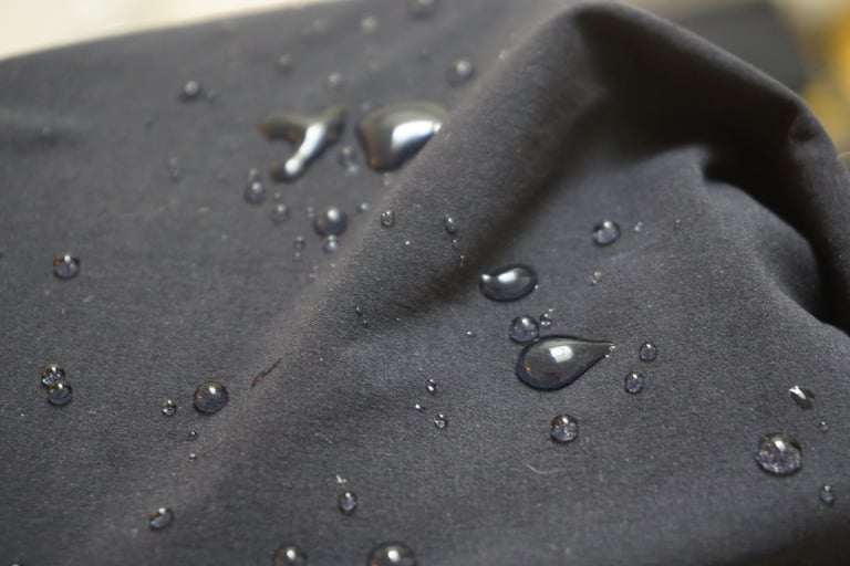 Water beads on the dark DWR-treated fabric of the Overland Selector shorts.