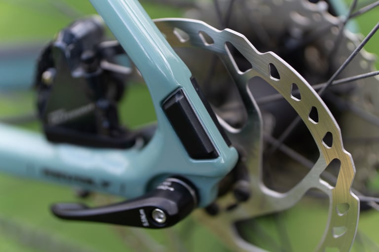 Giant Revolt Advanced rear dropout with black cover over the rack and mudguard mount, beside the disc rotor.