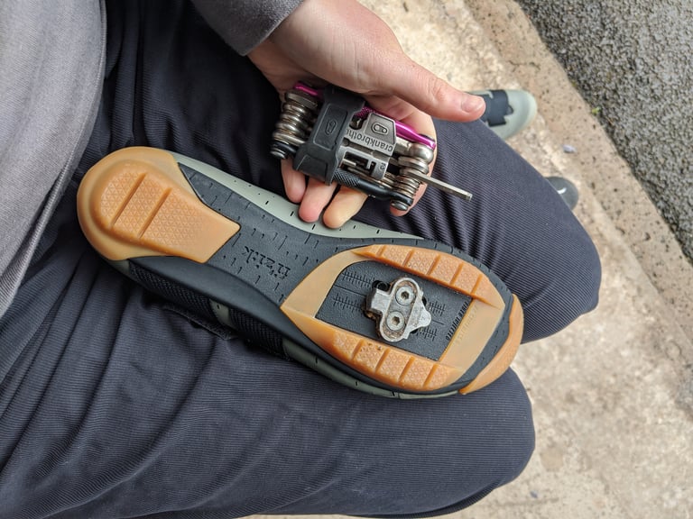 Sole of a Fizik Terra Powerstrap X4 with a two-bolt SPD cleat fitted and the gum rubber tread around it.