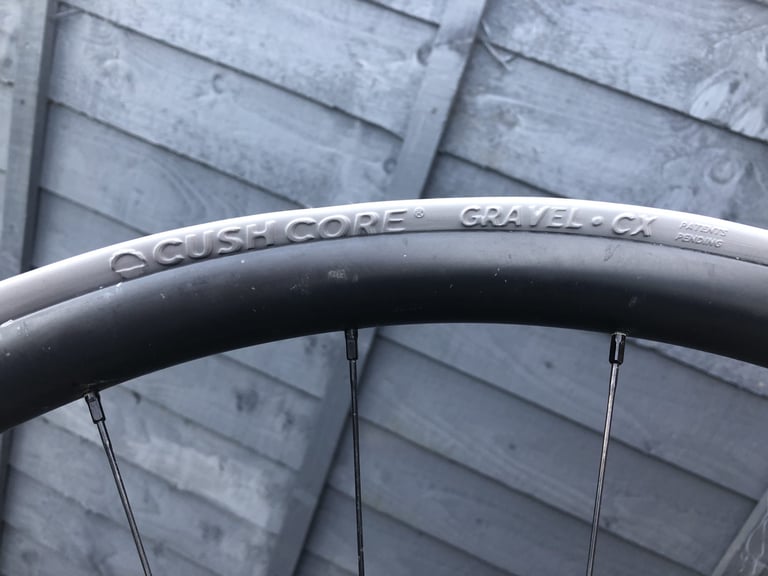 CushCore Gravel-CX insert seated in a wheel rim, its moulded logo visible, before the tyre is fitted.