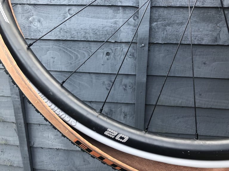 CushCore insert showing between the rim and the bead of a tan-wall gravel tyre during fitting.