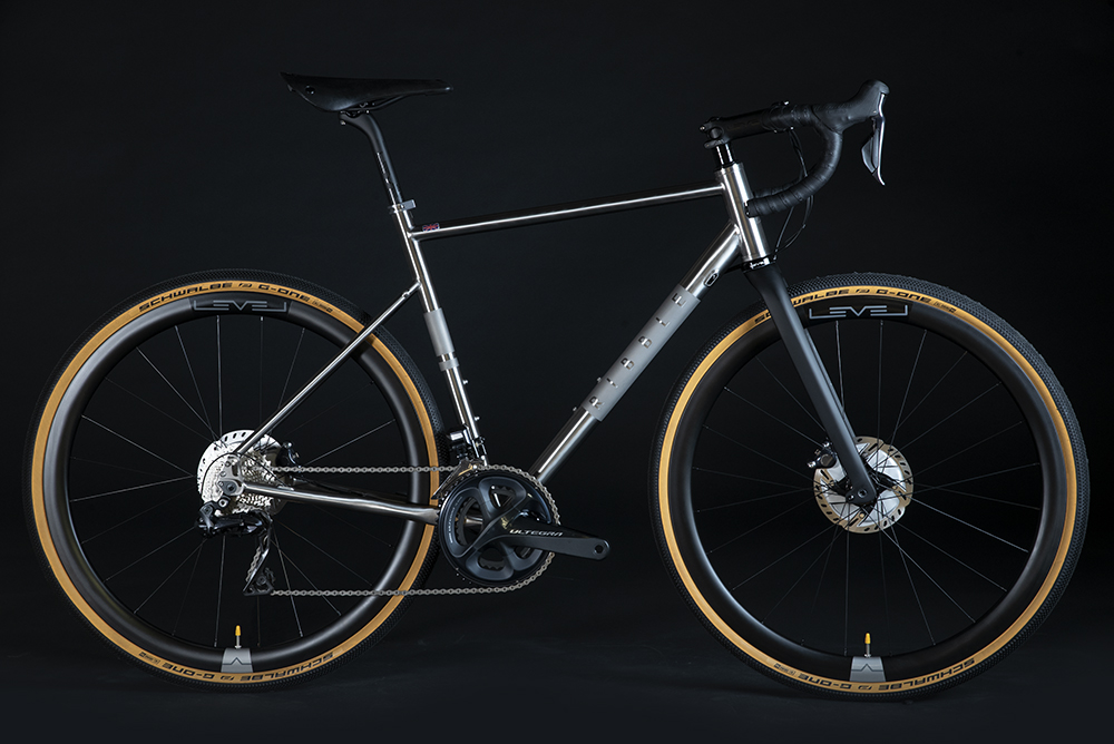 Side view of the Ribble CGR Ti Pro gravel bike with Ultegra Di2 on a black studio background.