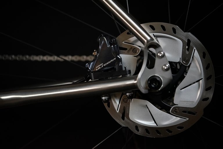 Shimano Ultegra flat-mount disc brake caliper and rotor at the rear dropout of the Ribble CGR Ti.