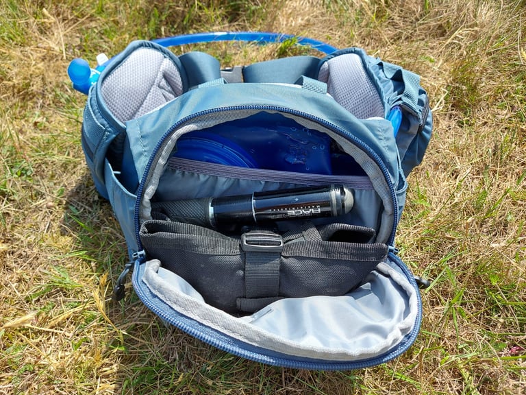 Open main compartment of the Camelbak Repack LR 4 with reservoir, mini-pump and organiser pocket inside.