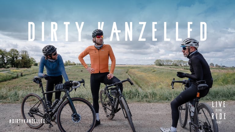 Dirty Kanzelled promo graphic with three riders chatting on Specialized bikes, Live Slow Ride Fast logo at right.