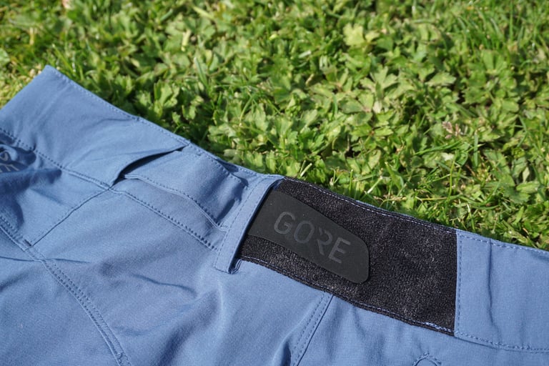 Close-up of the GORE-branded tab and black loop patch on the rear waistband of the C5 shorts.