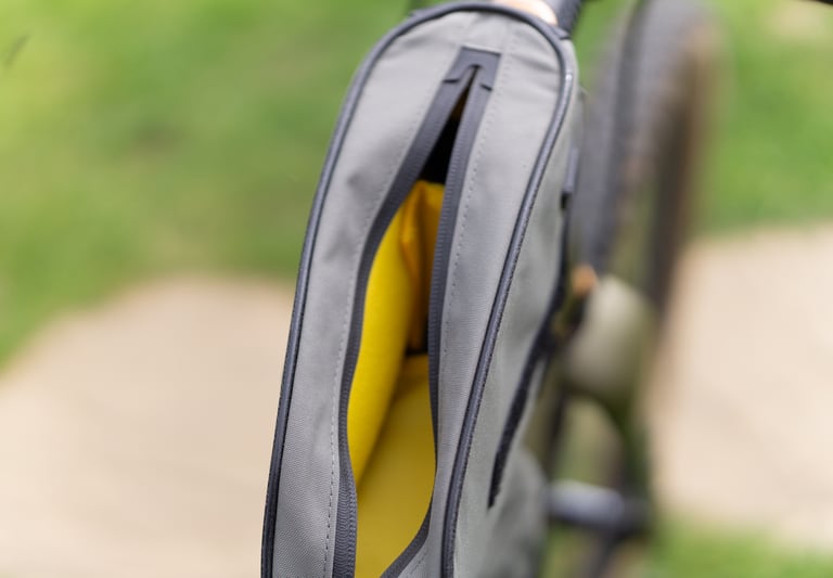 Topeak Toploader top tube bag partly unzipped to show its bright yellow lining.