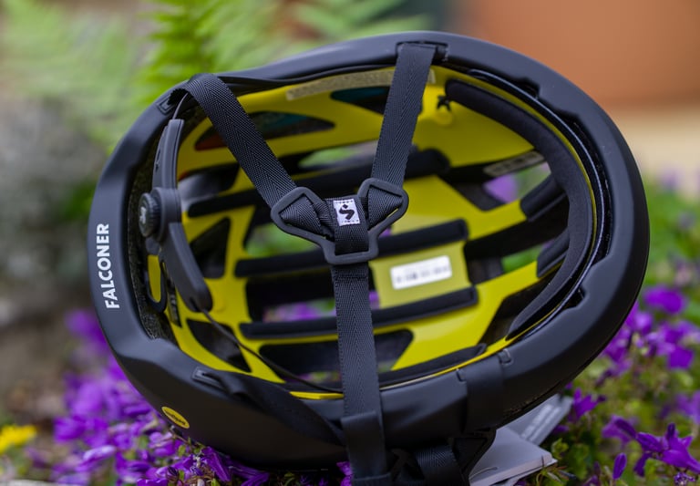 Inside the Falconer II helmet, showing the yellow MIPS liner, black straps and OCCIGRIP dial.