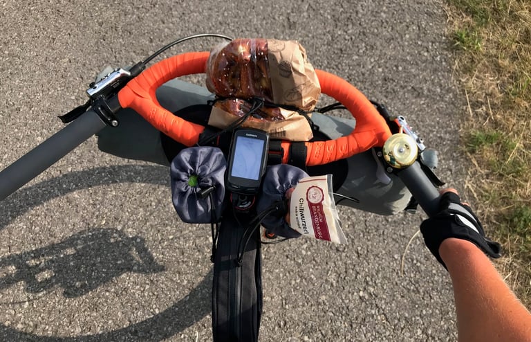 Bag of pretzels, a Garmin GPS and a chilli sausage snack stuffed inside orange Jones loop bars on the Grenzsteintrophy.