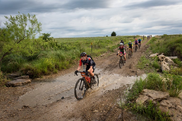 Katherine Moore leads a line of Dirty Kanza riders through a creek crossing on a Flint Hills dirt road in Kansas.