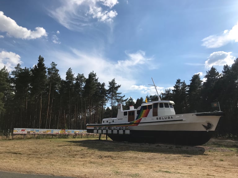 Greenpeace ship Beluga on display beside a pine forest in Lüchow-Dannenberg, passed during the Grenzsteintrophy.