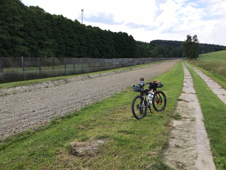 WTB 2.8in tyre and Lauf TR29 fork beside a hole in a concrete Panzerweg plate on the Grenzsteintrophy.