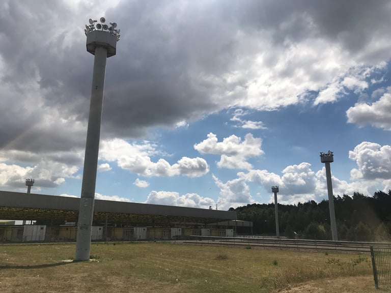 Tall loudspeaker masts beside the old checkpoint canopy at Marienborn on the former inner German border.