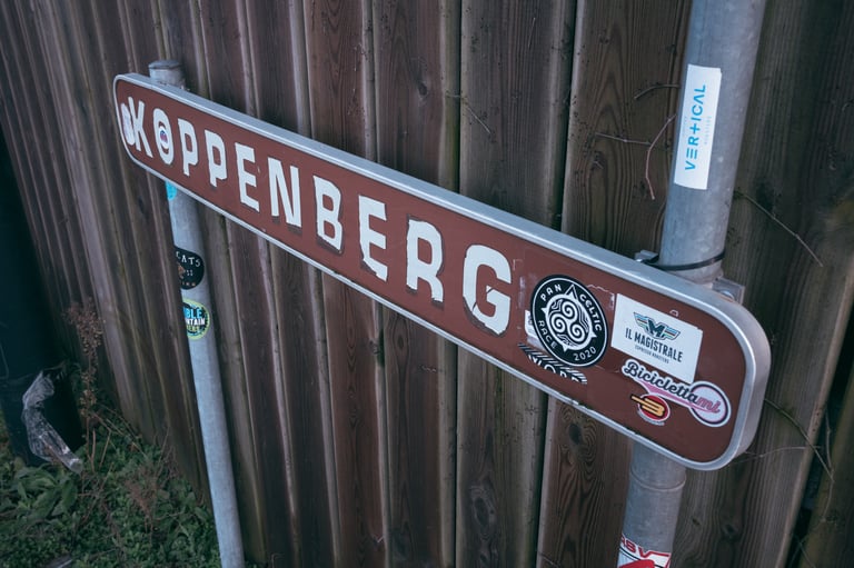 Brown Koppenberg road sign covered in stickers, on the famous cobbled Flemish climb visited by the Santa Cruz riders.