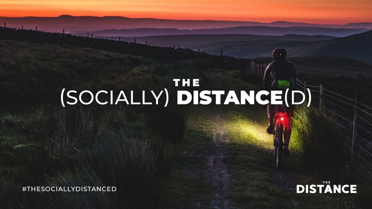 Dusk moorland track with a rider's red rear light glowing, on the third The (Socially) Distance(d) event banner.