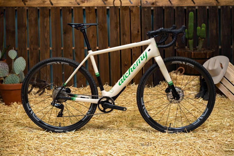 Alchemy E-Ronin e-gravel bike in cream with green graphics and drop bars, shown at the ENVE Builder Round-Up.