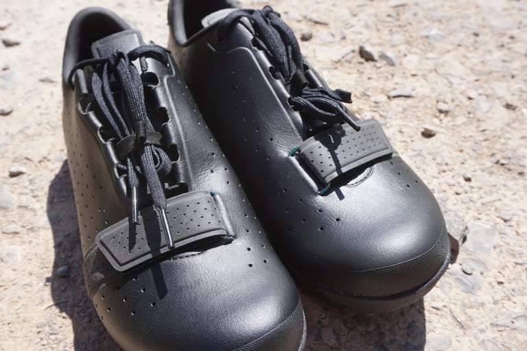 Close view of the lace and velcro strap closure on the Rapha Explore Shoes, with elastic loop for tucking laces.