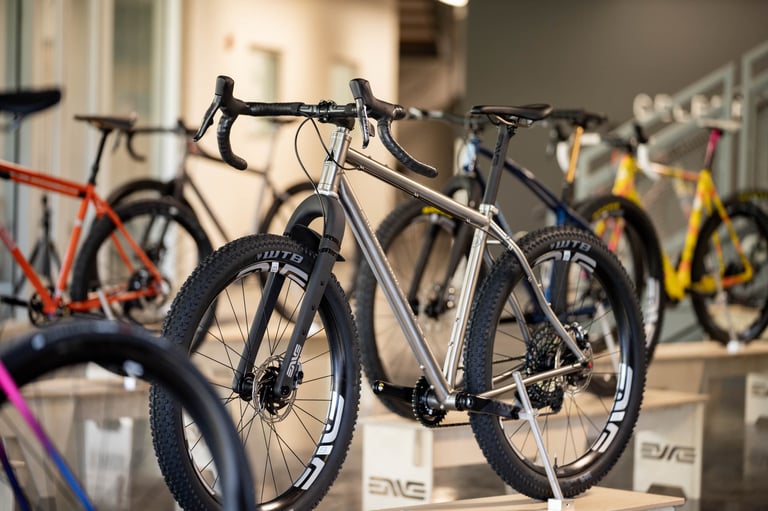 Titanium drop-bar bike on knobbly WTB tyres and ENVE wheels, on a plinth among custom builds at the Builder Round-Up.