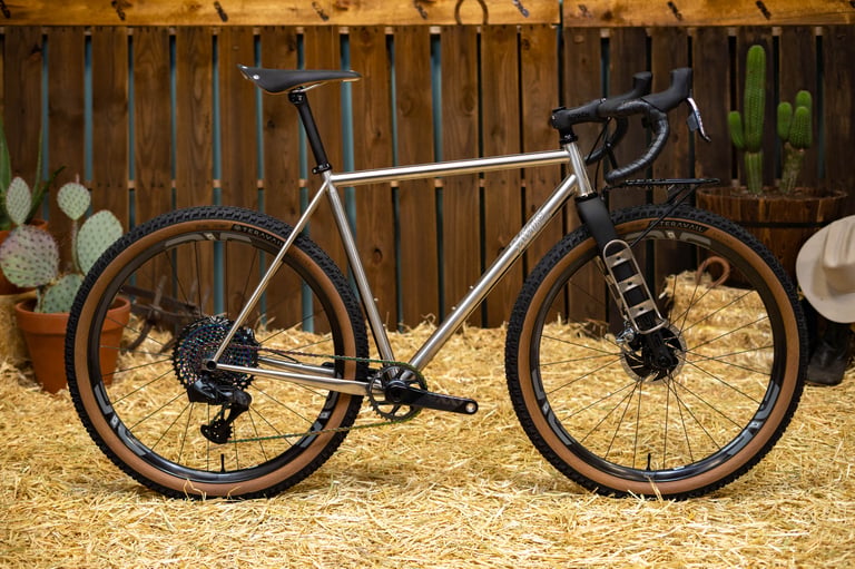 Horse Cycles Monster Gravel in stainless steel with the new ENVE Adventure Fork, front rack and Teravail tan-wall tyres.