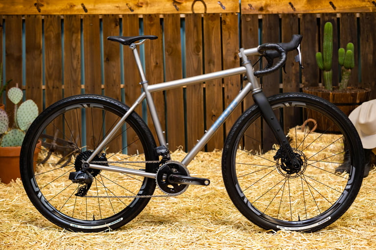 Moots Routt 45 titanium gravel bike with ENVE fork and wheels and a SRAM Force groupset, shown on straw.