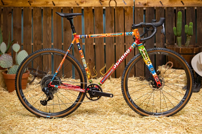 Scarab Páramo steel gravel bike with hand-painted orange, blue and green frame, built for the ENVE Builder Round-Up.