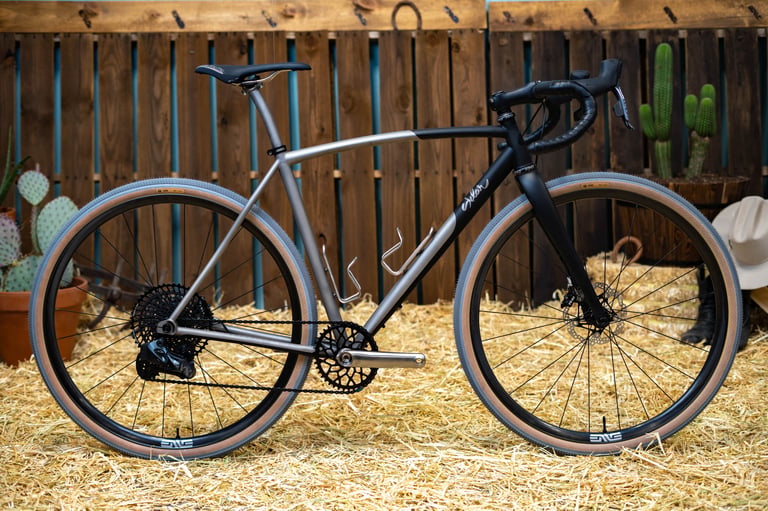 Sklar All Road titanium gravel bike with swooping top tube, black fork and grey Ultradynamico Cava tyres with tan walls.