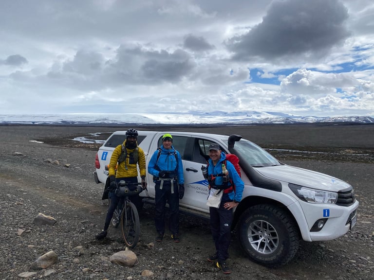 Natt Williams and two French hikers stand beside a Vatnajökull National Park truck on the Iceland Divide.