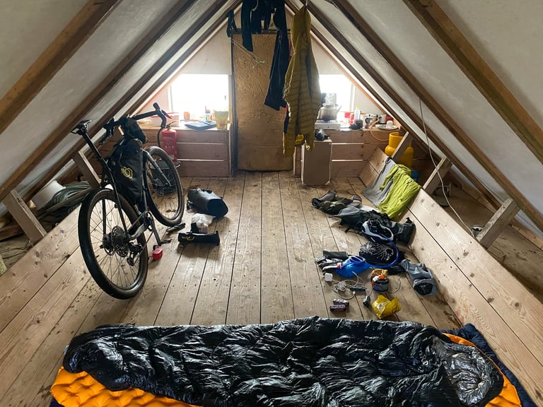 Bike, sleeping bag and drying kit fill the loft of the small Öldufellsleiõ mountain hut on the Iceland Divide.