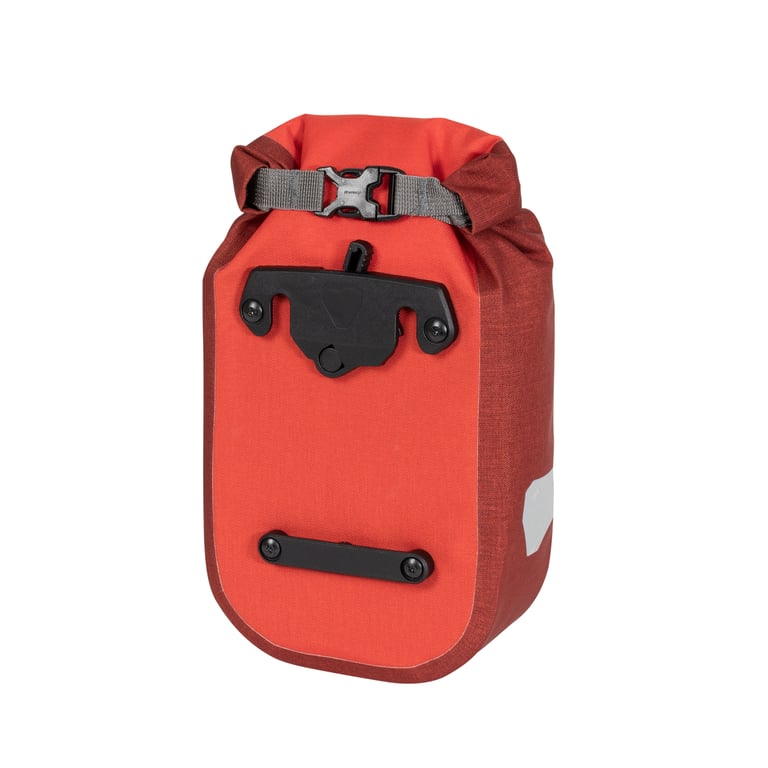 Ortlieb fork pack in red, seen from the back with its quick-release mounting bracket and roll-top buckle.