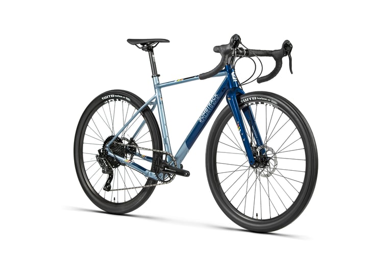 Bombtrack Audax AL in glossy two-tone blue with drop bars and WTB Horizon 47 tyres, studio three-quarter view.